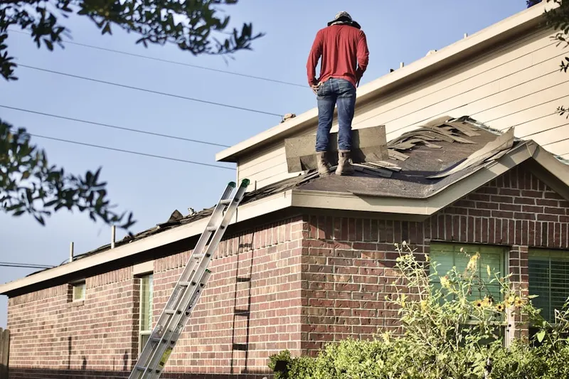 Professional roofer working on a residential roof in West Rockville